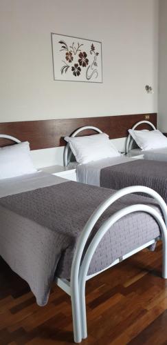 dos camas sentadas una al lado de la otra en un dormitorio en Hotel Sporting, en Campagnola Emilia
