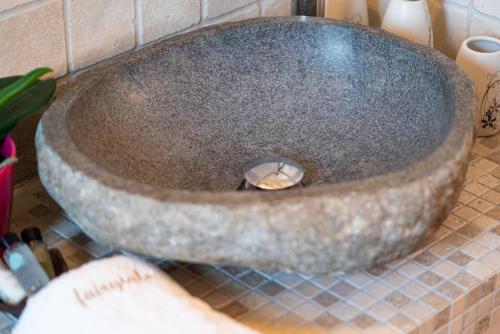 a stone sink on a counter in a bathroom at Fairytale Villa in Lefkada Town