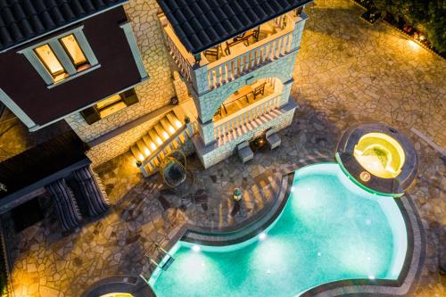 an overhead view of a swimming pool in front of a building at Fairytale Villa in Lefkada Town