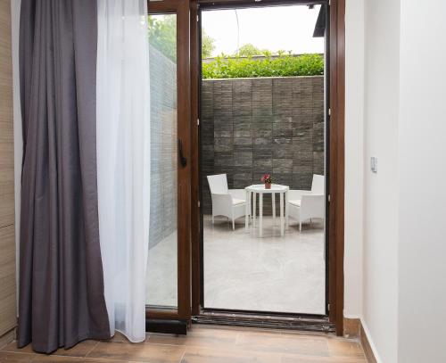 a sliding glass door leading to a patio with a table at Princess Residence in Istanbul