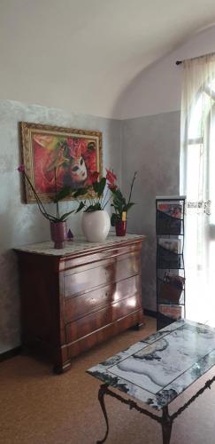 a room with a table and a painting on the wall at Hotel Sporting in Campagnola Emilia