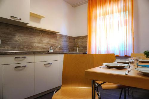 a kitchen with a wooden table and a wooden counter top at Gästehaus am Oberlausitzer Dreieck in Bertsdorf