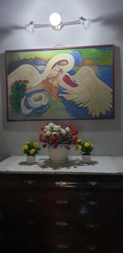 a painting of two birds and flowers on a dresser at Hotel Sporting in Campagnola Emilia