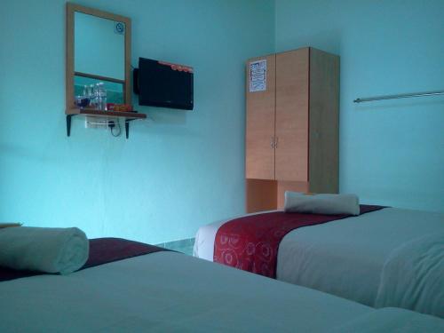 Ένα ή περισσότερα κρεβάτια σε δωμάτιο στο Rose Inn Motel