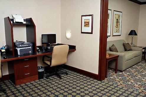 a room with a desk with a computer and a couch at Staybridge Suites - Philadelphia Valley Forge 422 by IHG in Royersford