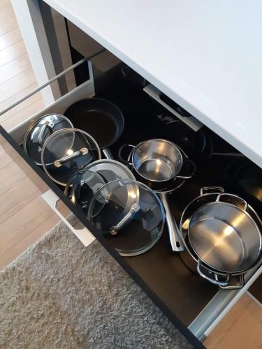 a bunch of pots and pans sitting on a stove at Apartment Zama in Štrbské Pleso