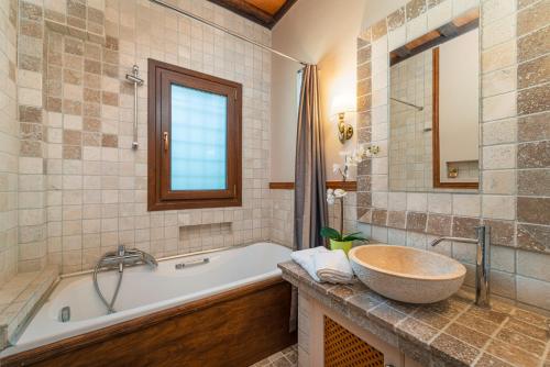 a bathroom with a tub and a sink at Fairytale Villa in Lefkada Town