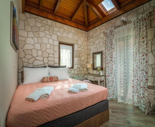 a bedroom with a bed with two towels on it at Fairytale Villa in Lefkada Town