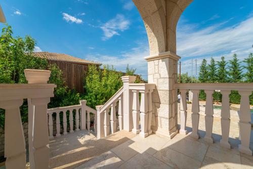 a balcony with a white railing and a fence at Fairytale Villa in Lefkada Town