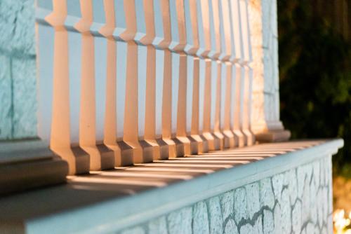 a white fence on top of a porch at Fairytale Villa in Lefkada Town