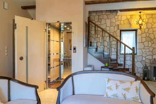 a living room with a couch and stairs at Fairytale Villa in Lefkada Town