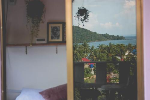 a view of the ocean from a room with a window at DAHLIA Guesthouse in Koh Rong Sanloem