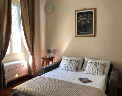 a bedroom with a bed and a window at Luxury Fiesolana apartment in Florence