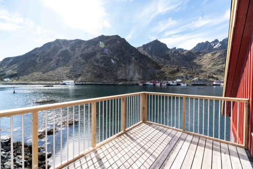 a balcony with a view of the water and mountains at Hemmingodden Lodge in Ballstad