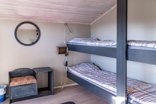 a room with two bunk beds and a mirror at Kumlinge Stugor in Kumlinge