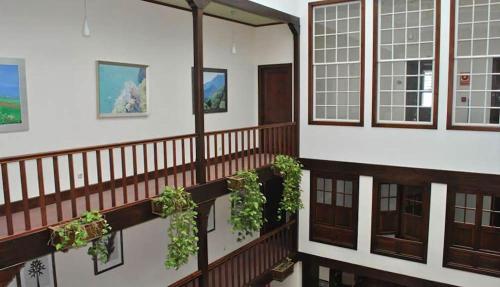 a balcony of a building with potted plants at Hotel Rural Victoria - La Orotava in La Orotava