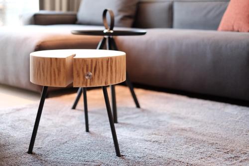a wooden stool in a living room next to a couch at Fritz Lauterbad in Freudenstadt