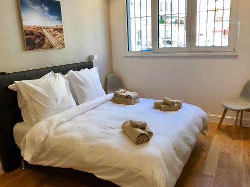 a bedroom with a bed with towels on it at Sea View- Easy Home Booking in Nice