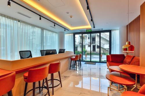 a bar in a restaurant with red chairs and tables at Hotel Fagus by Aycon in Budva