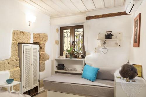 a room with a bed and a window at House Erofili in Chania