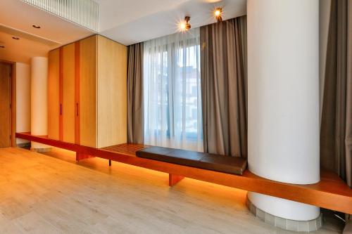 a room with a bench in front of a window at Hotel Fagus by Aycon in Budva