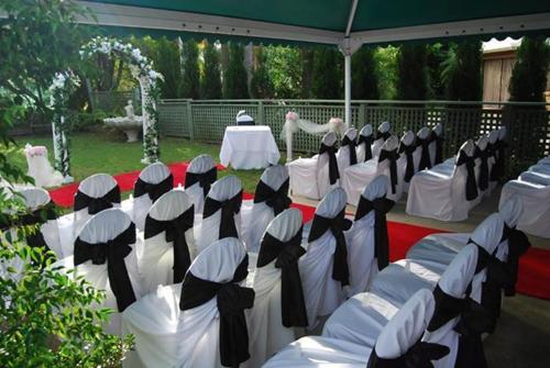 a group of tables and chairs with white and black at Abcot Inn in Sylvania