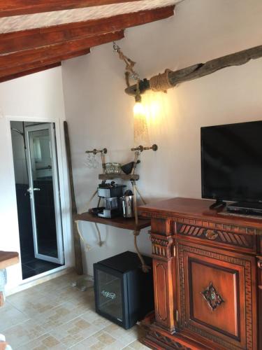 a living room with a television on a wooden table at Sinemoria Guest House in Sinemorets