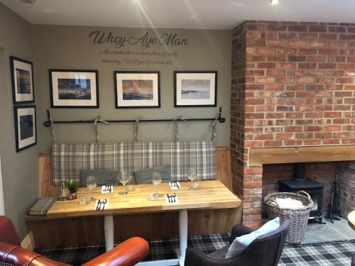a dining room with a table and a fireplace at The Sunningdale in Bamburgh