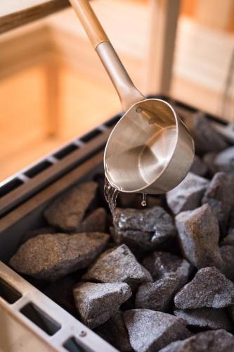 a spoon in a tray filled with rocks with ailit at Medlefors Hotell & Konferens in Skellefteå