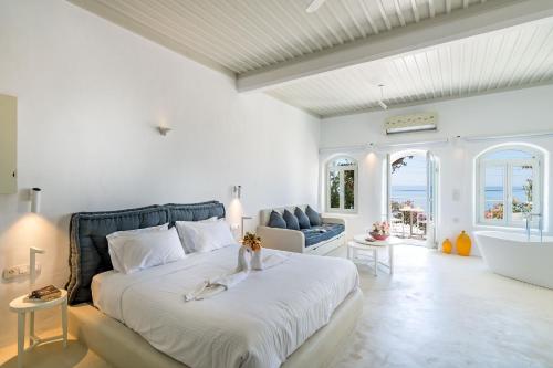 a bedroom with a large bed and a bath tub at Samaria by the Sea in Khóra Sfakíon