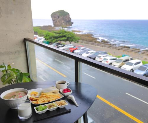 a tray of food on a table on a balcony at Jing Guan Hotel in Eluan