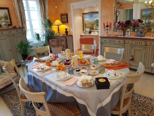 a table with food on it in a kitchen at Chambres d'Hôtes Saint Roch in Tournecoupe