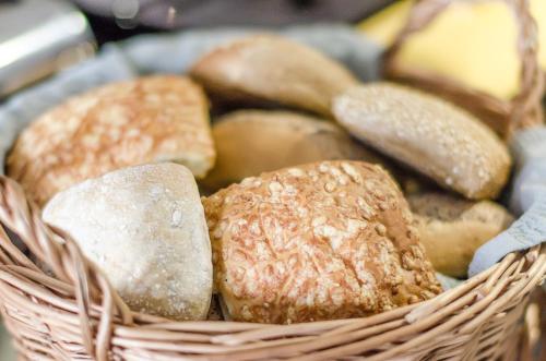a basket filled with different types of bread at Maude´s Hotel Enskede Stockholm in Stockholm