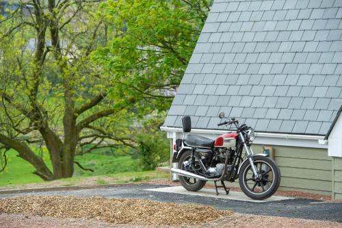 a motorcycle parked in front of a house at The Poltimore Inn in North Molton