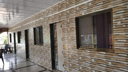 a brick wall with windows on the side of a building at Kulswami Cottage Alibag in Alibaug