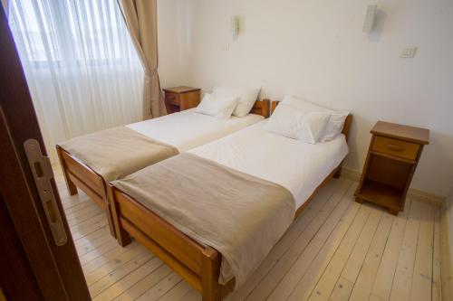 a bedroom with two beds and a window at Hotel Polar Star in Žabljak