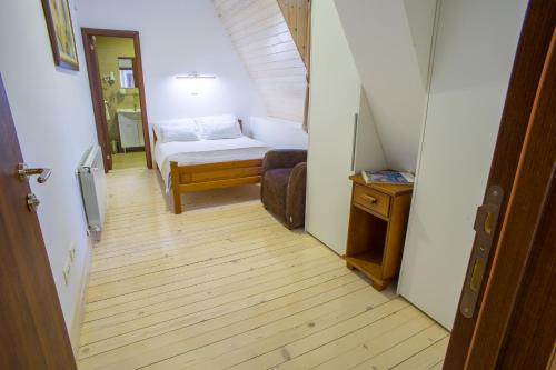 a hallway with a room with a bed and a table at Hotel Polar Star in Žabljak