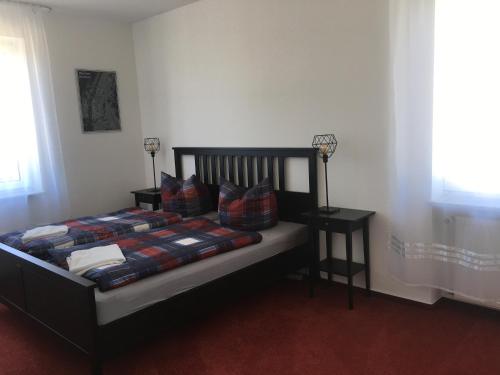 a bedroom with a bed with pillows and a window at Jimmy Gastronomie & Übernachtung in Altheim