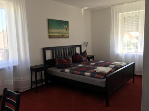 a bedroom with a bed in a room with windows at Jimmy Gastronomie & Übernachtung in Altheim
