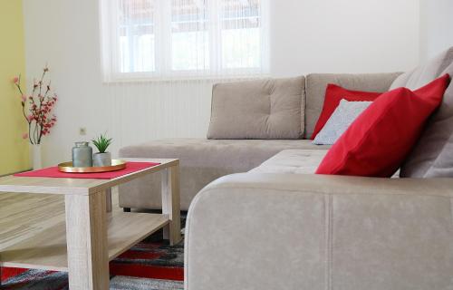 a living room with a couch and a table at Apartments Neda in Ploče