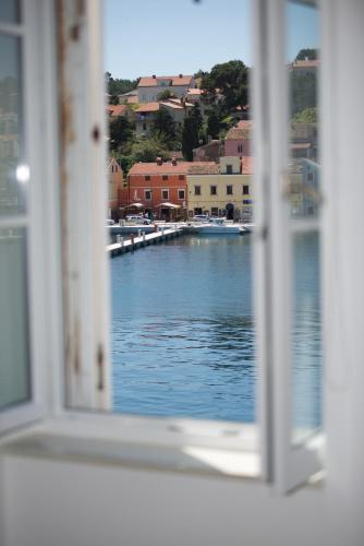 a view of a river from an open window at Apartments and Rooms Jospino in Mali Lošinj
