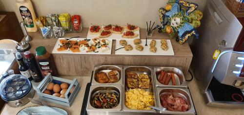 a table with many plates of food on it at Ines bed and breakfast in Giardini Naxos