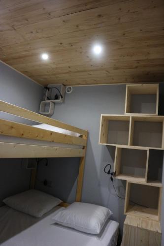 two bunk beds in a room with wooden ceilings at Hameau du Borsat in Tignes