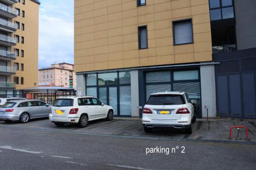 three cars parked in a parking lot in front of a building at 100 Viale Italia in La Spezia
