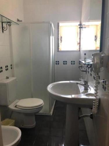 a bathroom with a sink and a toilet and a shower at Life Hotels Residence dei Baroni in Siracusa