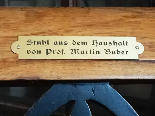 a sign on a wooden shelf with a pair of scissors at Diana's B&B in Jerusalem