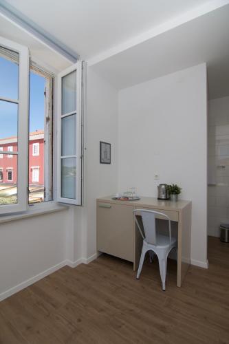 an empty room with a desk and a window at Apartments and Rooms Jospino in Mali Lošinj