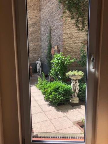 a door leading into a garden with a patio at Hotel Gunia in Berlin