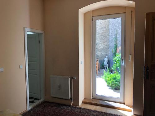 an empty room with an open door with a window at Hotel Gunia in Berlin