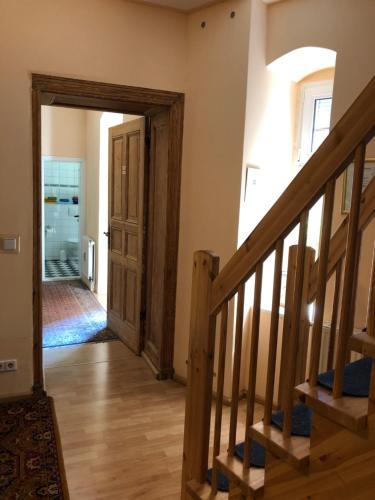 a hallway with a wooden stairway leading into a house at Hotel Gunia in Berlin
